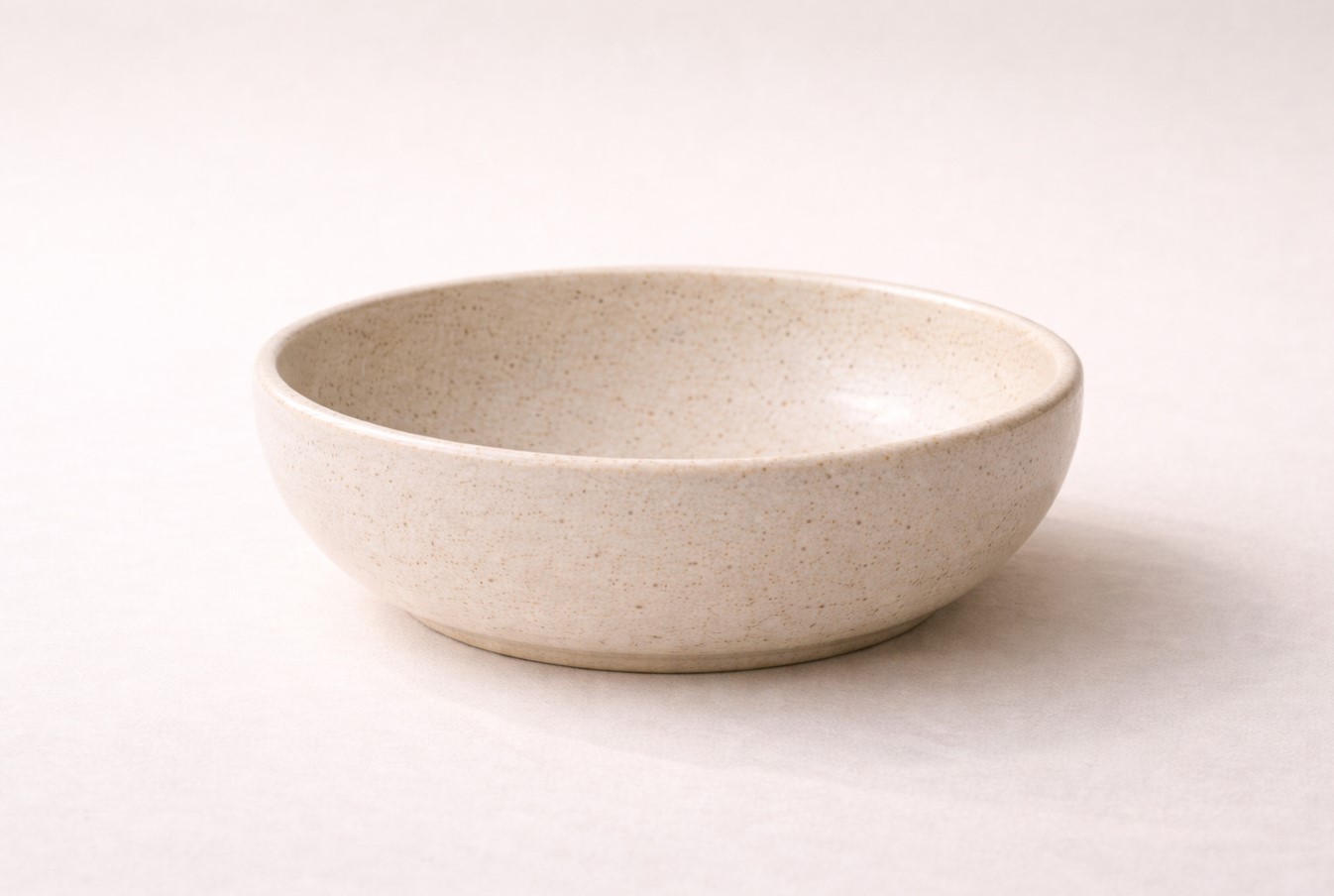 Studio packshot of XL handcrafted ceramic salad bowl on neutral background