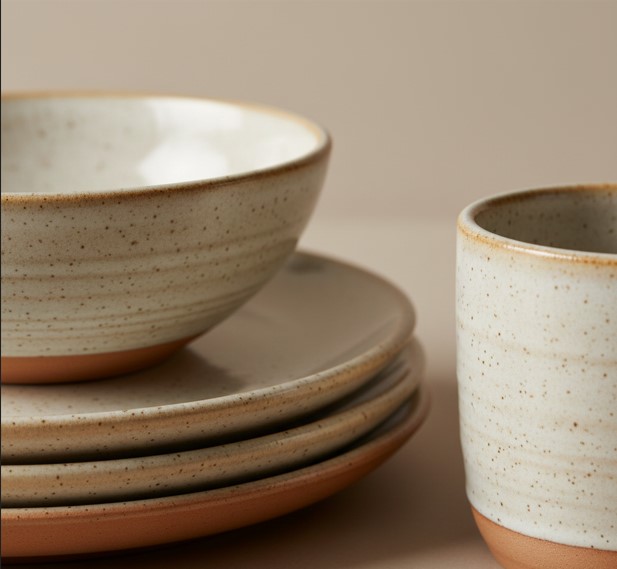 Close-up of handmade ceramic glaze texture on plates, bowls, and mugs